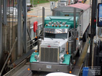 A Peterbilt truck gets on the Armand Imbeau ferry